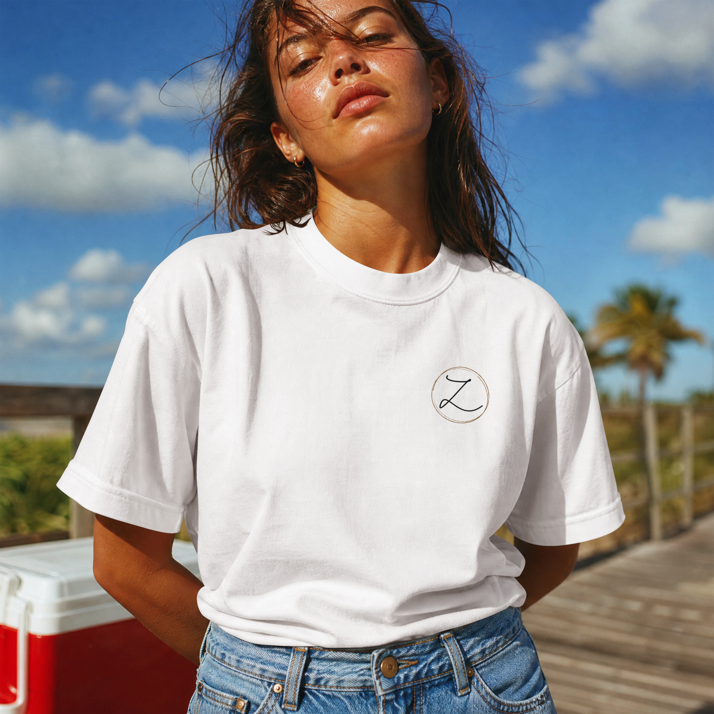 White tee with a small circled Z on the left chest